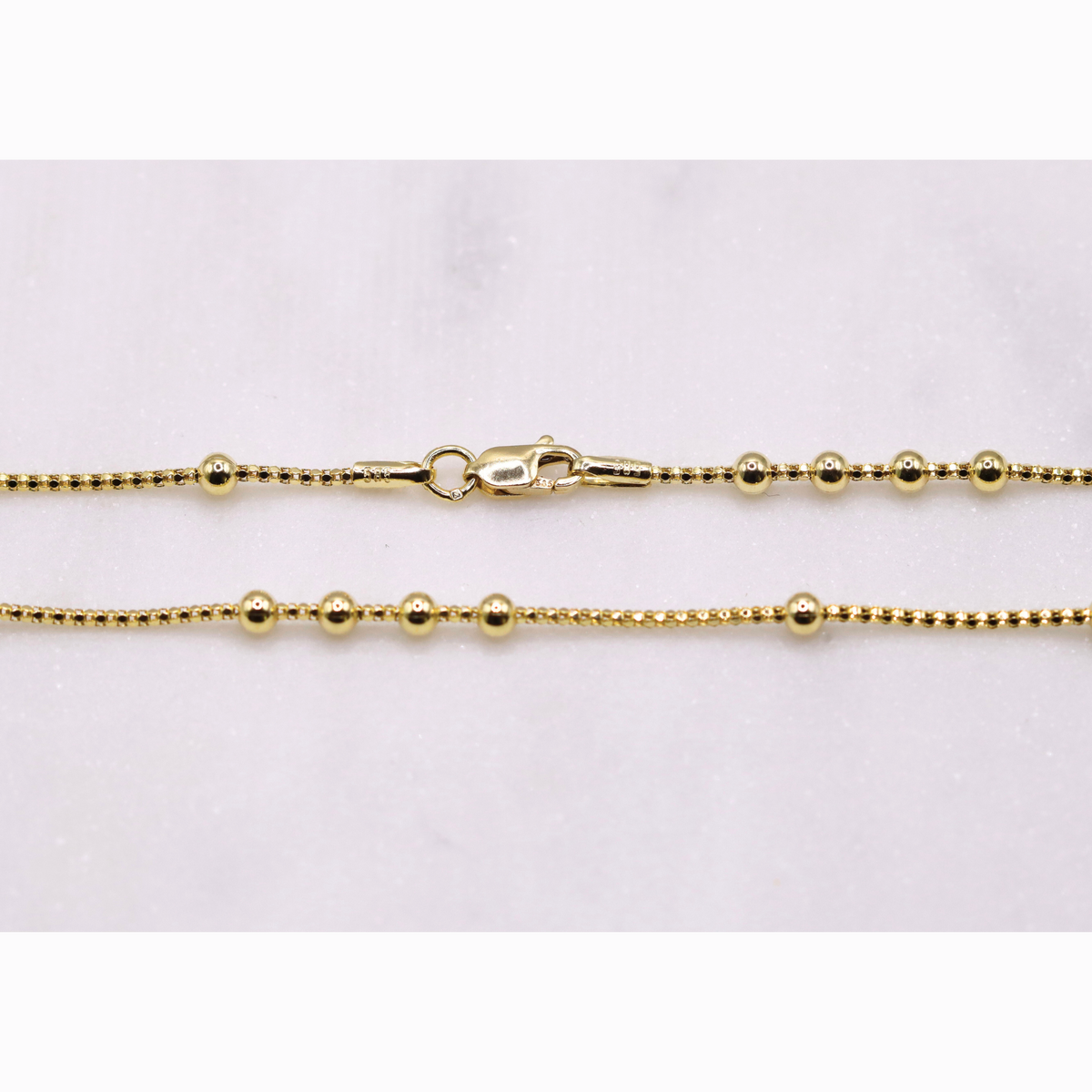 Bolletjes station ketting 3 mm 14k goud, detail van de sluiting